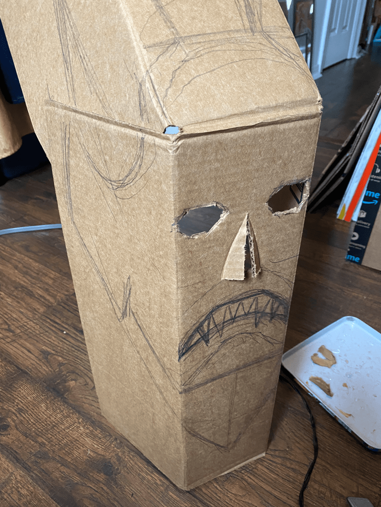 cardboard mask step two with nose and eye holes cut out