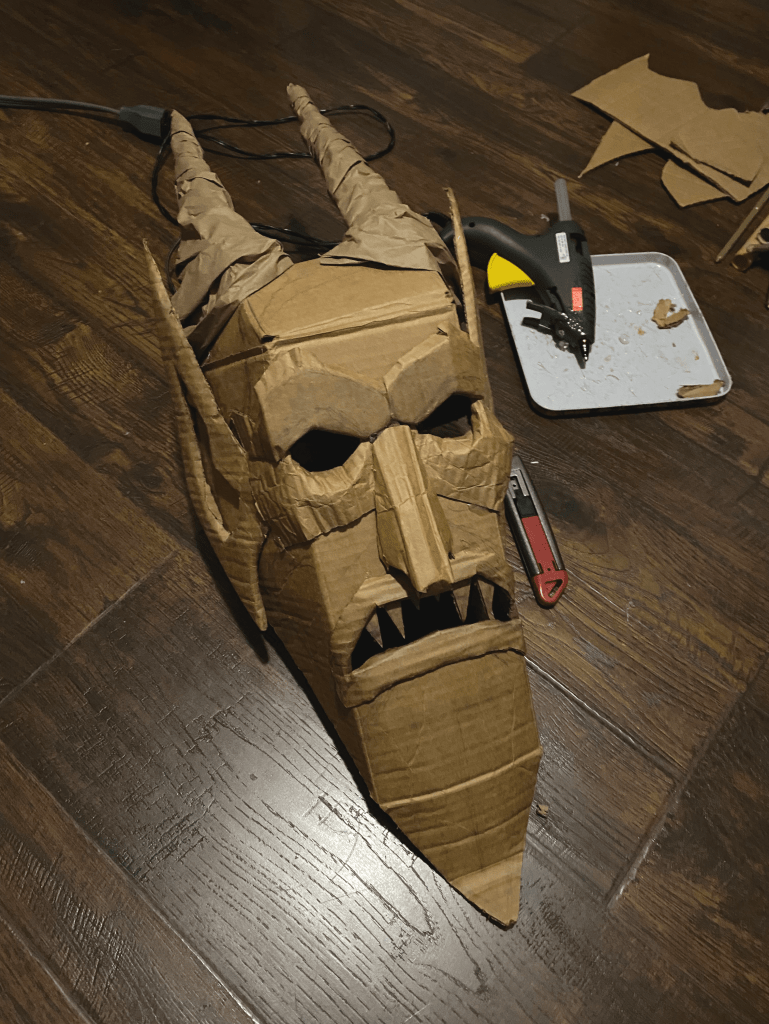 carboard mask step four with added cardboard features nose ears and horns