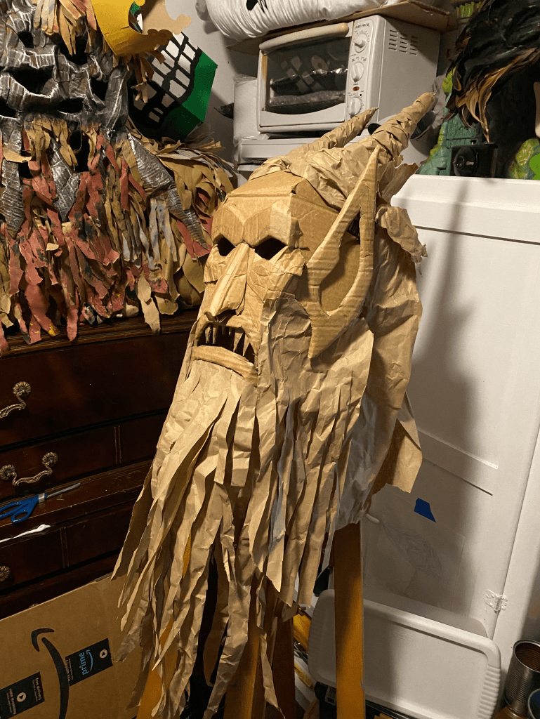cardboard mask step five nearly finished with paper strands of hair and beard added