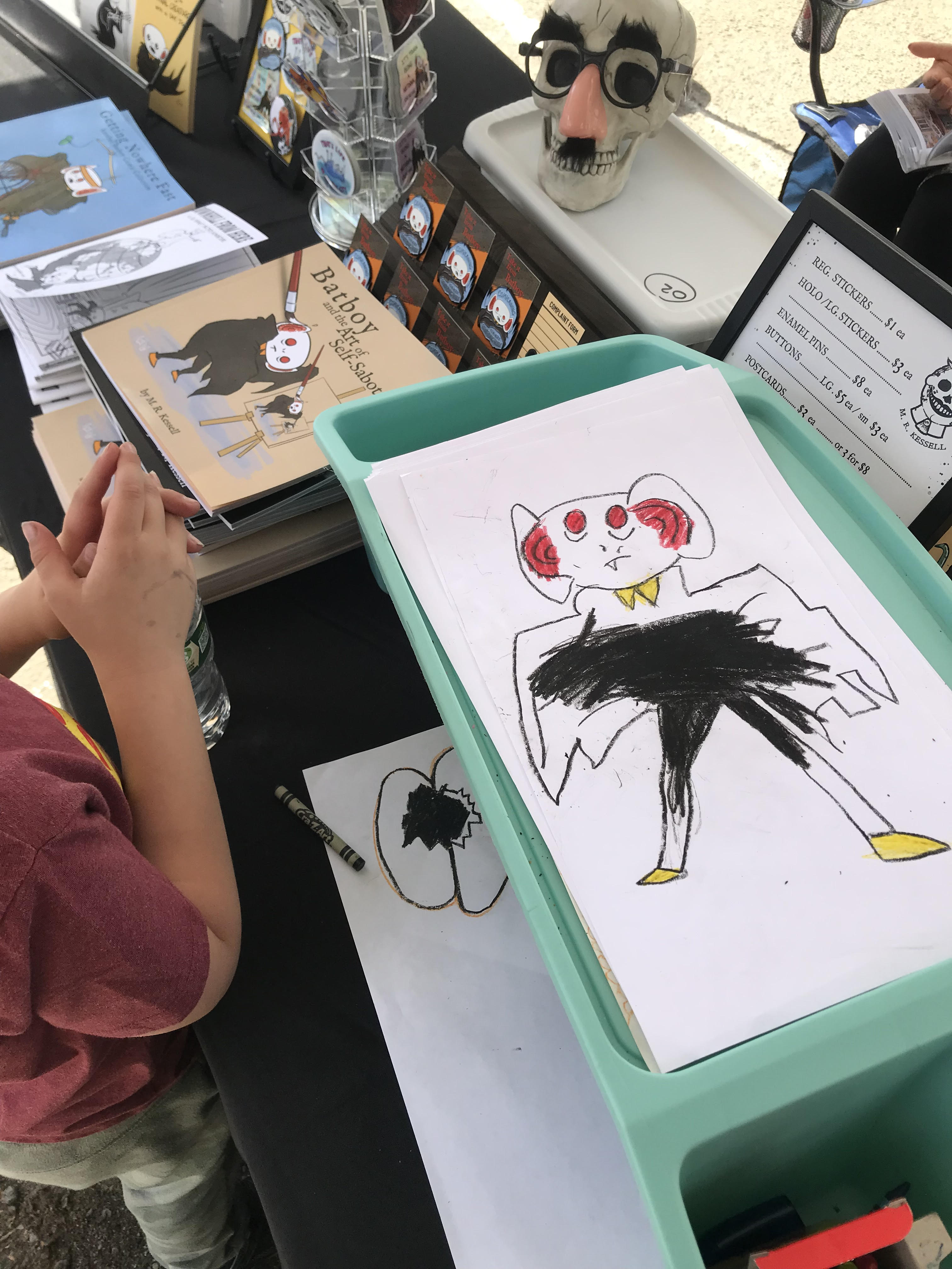 a child's drawing of bat boy at an art festival