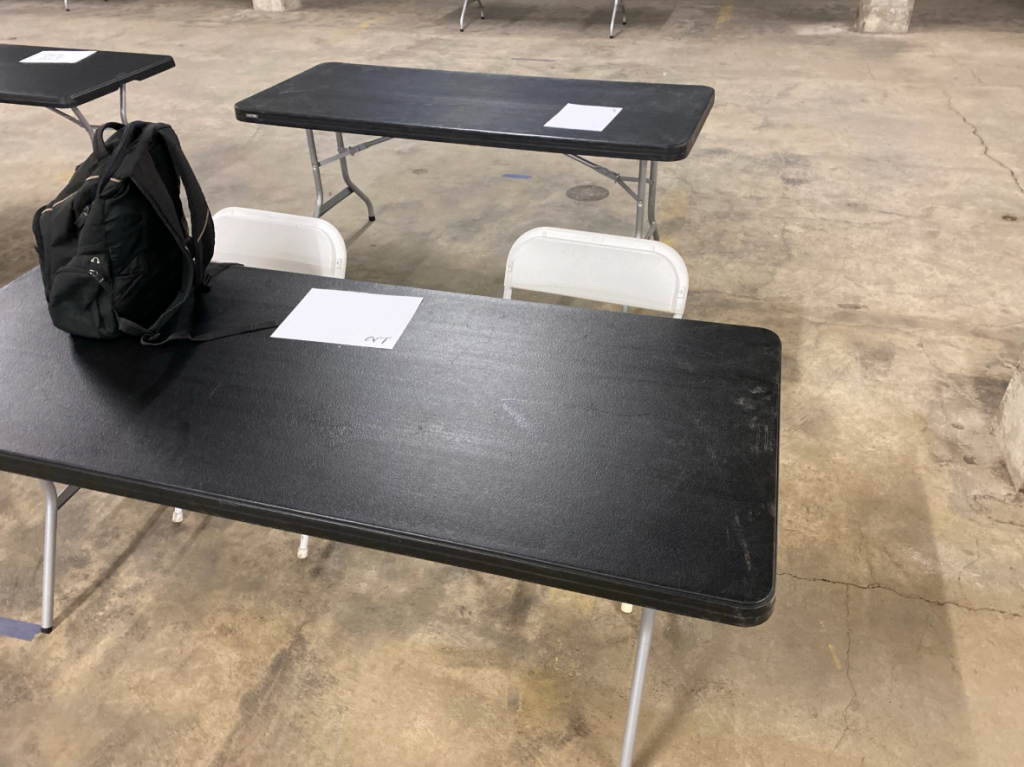 a few tables in an empty convention hall